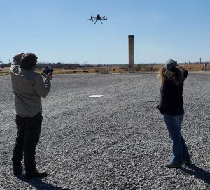 Wesley T. Honeycutt piloting a UAS in the field after obtaining his UAS license. To the right is his colleague, Liz Pillar-Little.